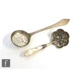A Victorian hallmarked silver caddy spoon with embossed fruit to a rounded hexagonal bowl below