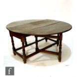 An 18th Century oak oval gate leg dining table with single end drawer, on turned baluster block legs