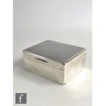 A hallmarked silver rectangular cigarette box with engine turned decoration to hinged lid, length