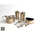 A hallmarked four piece silver cruet set of oval outline, the plain body engraved with a Phoenix