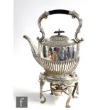 A hallmarked silver spirit kettle raised on four paw feet stand encompassing burner, all below