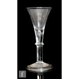 An 18th Century drinking glass circa 1740, the drawn trumpet bowl above a teared plain stem with