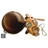 A World War Two British tin helmet and a Belgian gas mask. (2)