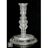 A 19th Century clear crystal glass candlestick or section of a lamp base, having a wide domed foot
