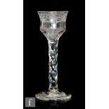 An 18th Century drinking glass circa 1785, the waisted ogee bowl engraved to the upper rim with a