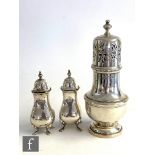 A silver hallmarked sugar sifter of ribbed baluster form with pierced pull off cover and finial, all