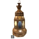 An iron garden candle light fitting with coloured glass panels with suspension loop, height 62cm,