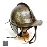 An English civil war period lobster tail helmet with adjustable visor and side riveted ear covers,