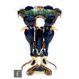 A late 20th Century majolica style pedestal fruit bowl formed with three stylised elongated birds