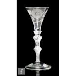 An 18th Century Jacobite drinking glass circa 1755, the trumpet form bowl engraved with rose and bud