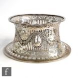 A hallmarked Britannia silver dish ring, with embossed swag detailing and oval roundels, pierced