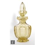 A late 19th Century Bohemian yellow glass cologne bottle of footed faceted form with flared