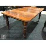 A Victorian mahogany extending dining table on turned reeded legs, with additional leaf,