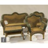 A plastic wicker garden suite comprising a two-seater sofa, two chairs and a matching table,