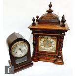 A late Victorian walnut cased mantle clock with eight day striking movement, silvered dial with