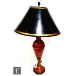 A 20th century red lacquered and painted Chinoiserie baluster table lamp and shade, decorated with