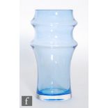 A Dartington glass vase of tapered cylinder form with two ribbed bands in a pale blue ground, acid