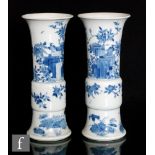 A pair of Chinese 19th Century blue and white Gu vases, each with spreading circular base rising