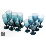 A set of six post war Swedish dark indigo wine glasses by Gullaskruf, each with an elongated ovoid