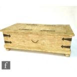 A 20th Century stripped pine metal strapped blanket or storage chest, on bun feet, 46cm x 77cm x