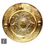 A 20th Century brass charger in the 17th Century style with rampant lions to each side of a