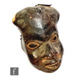 A 19th Century Congolese face mask, leather covered, carved eyes and open mouth, 27cm.