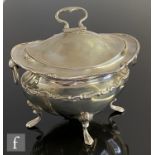 A silver hallmarked tea caddy, of boat shaped form with fluted body, raised on four padded feet,