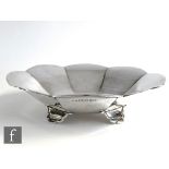 A hallmarked silver bowl of plain cushioned octagonal form raised on four scroll feet, diameter