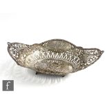 A late 19th Century continental silver oval bread basket decorated with embossed cherubs to a