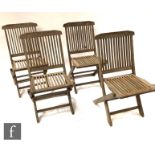 A set of eight teak folding slat back chairs and a matching table on separate legs A/F (9)
