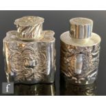 A silver hallmarked tea caddy of cylinder form, with embossed floral and embossed decoration, height