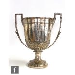 A Victorian hallmarked silver twin handled trophy, circular foot with still leaf decoration below