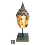 A Tibetan/Burmese giltwood Shakayumi Buddha figure, the head modelled with downcast eyes and high