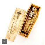 A miniature bone coffin with articulated skeleton,
