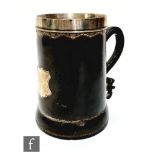 A late 18th early 19th Century stitched leather and silver mounted Blackjack tankard with