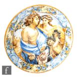 A 19th Century French faience maiolica plate decorated with a male figure with two ladies and a