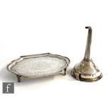 A Georgian hallmarked silver cushioned oval tea pot stand with bright cut decoration and raised on