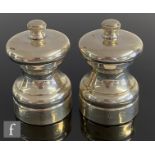A pair of silver hallmarked Peter Piper salt and pepper grinders, height 7cm, Birmingham 1991, P H