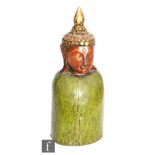 A Chinese/Tibetan carved wooden Buddha, the green painted plinth supporting a carved Buddha head