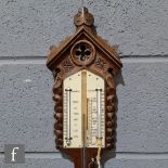 A late 19th Century Gothic Revival oak stick barometer, the architectural pediment above twin dry