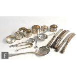 A small parcel lot of hallmarked silver items to include seven napkin rings, two spoons, a tea