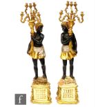 A large pair of 20th Century 'blackamoor' figures each holding a six branch candelabrum, painted