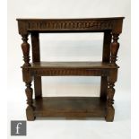 An 18th Century and later carved oak two tier buffet, the lunette decorated frieze united by