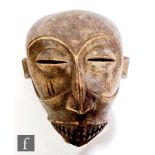 A 19th century Congolese face mask, pronounced lips and exposed teeth, 32cm.