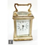 A white metal miniature carriage clock, Roman numerals to a white rectangular dial, height 8cm, with