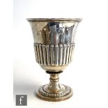 A Georgian hallmarked silver goblet, circular foot with part fluted embossed detail below conforming