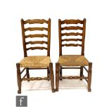 A near set of eight early 20th century ash and rush seat ladder back dining chairs including an