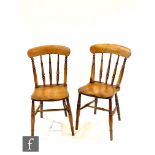 A harlequin group of six beech and elm lath back standard chairs on turned splayed legs united by