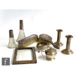 A small parcel lot of assorted hallmarked silver items to include two hair brushes, a pair of