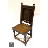 A 19th Century high back standard chair, the scroll carved lozenge panelled back mounted with two